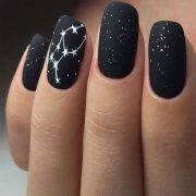 Black glitter nails with art of white stars